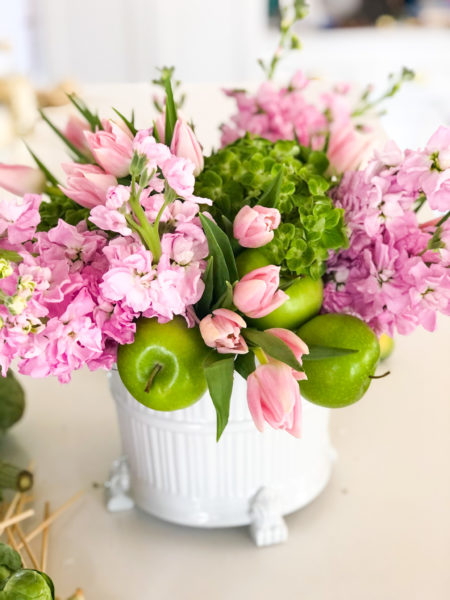 pink and green floral arrangement with green apples