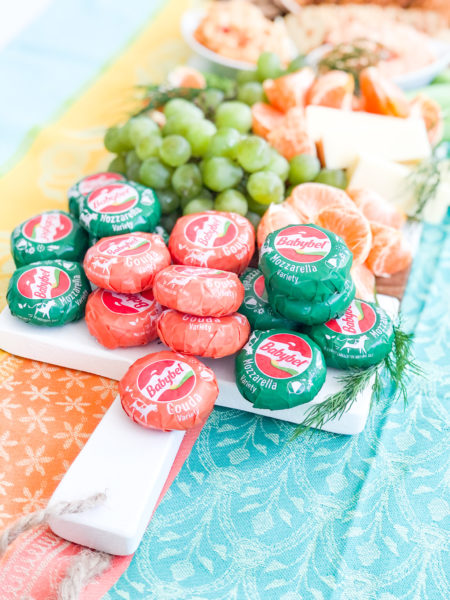 st patricks day cheese board with orange and green babybel cheese stacked