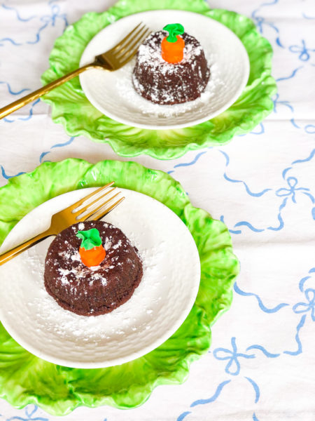 lava cakes with fondant carrot toppers on green lettuce plates