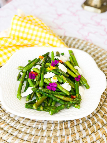 asparagus salad with cheese and topped with flowers
