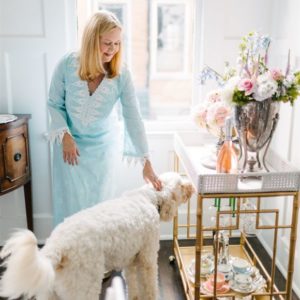 kentucky derby party ideas host with dog at bar cart