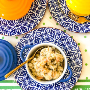 wild rice shrimp casserole in blue and white bowl with spoon