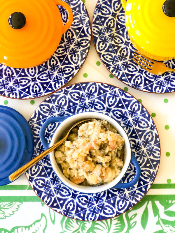 wild rice shrimp casserole in blue and white bowl with spoon