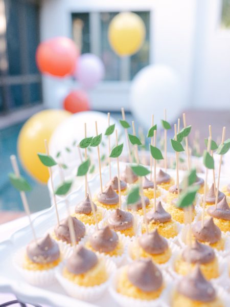 cake bites with chocolate frosting and balloons