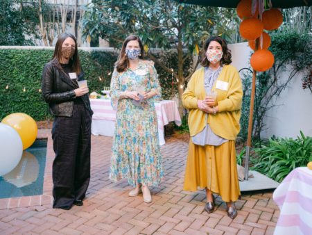 ladies at a patio party with masks and social distancing