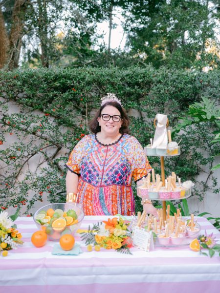 mk hennigan at party table with food and citrus flowers