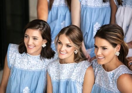 bridesmades in blue dresses and hazen earrings