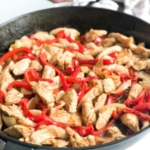 chicken-fajitas-with-onions-and-peppers-in-cast-iron-skiller