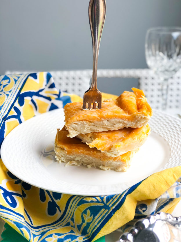 cheesy chicken enchiladas cut into slices with fork at top