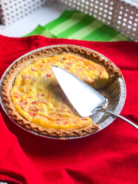 quiche with serving spoon