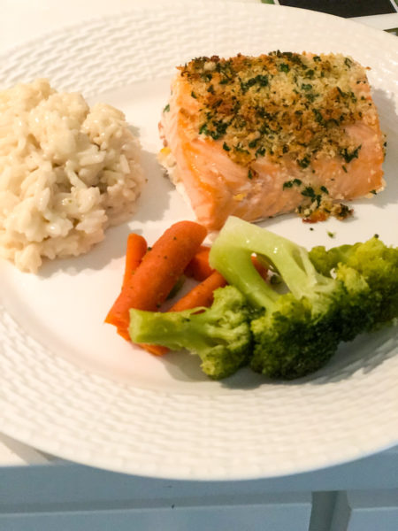 salmon with parsley and panko served with rice and broccoli on a white plate