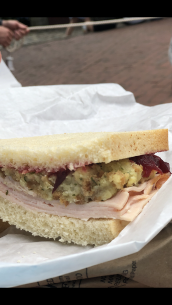 turkey sandwich with dressing and cranberry sauce on white bread