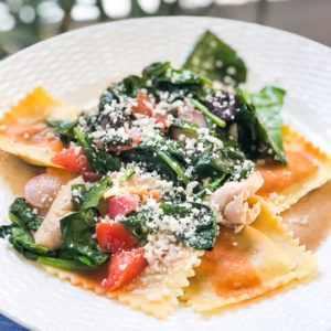 ravioli with spinach and tomatoes and cheese