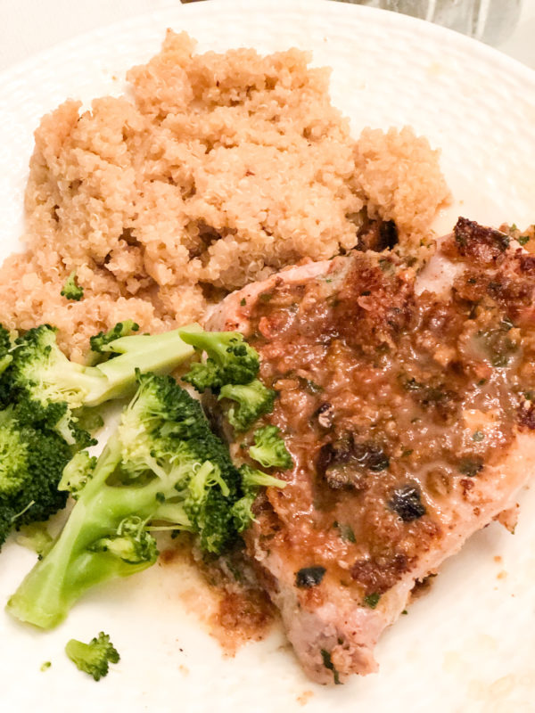 pork chop with parsley and sides of quinoa and steamed broccoli