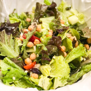 greek salad with chick peas in white salad bowl