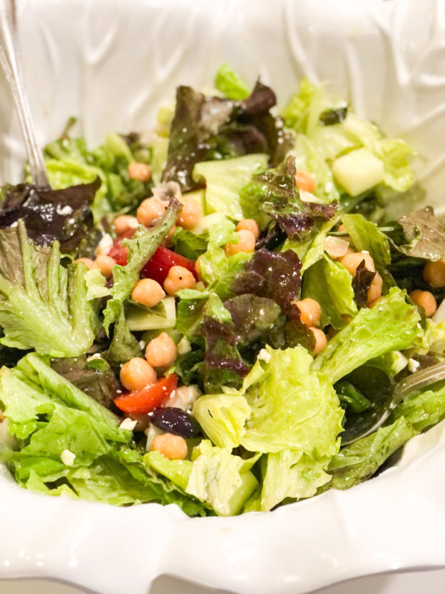 greek salad with chick peas in white salad bowl