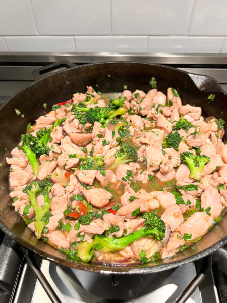 basil chicken in cast iron skillet with broccoli