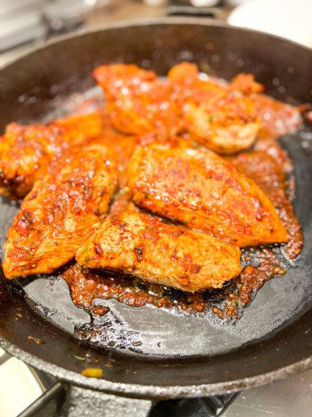 chicken ole with salsa and mustard marinade in cast iron skillet