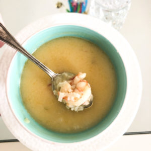 spicy thai shrimp soup in blue bowl and white plate