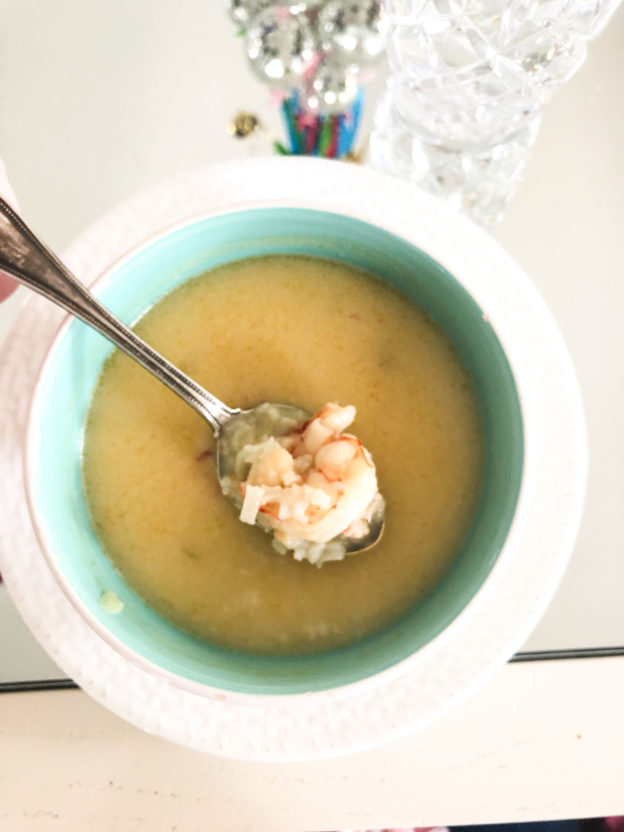 spicy thai shrimp soup in blue bowl and white plate