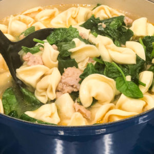 totellini soup with spinach and sausage in large blue pot