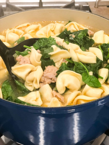 totellini soup with spinach and sausage in large blue pot