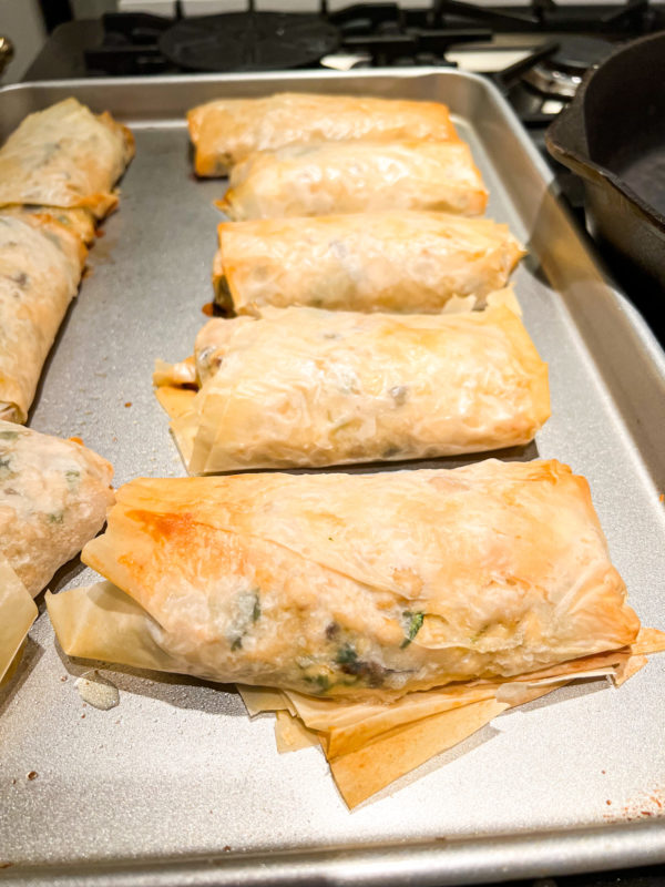 chicken mushroom phyllo rolls on silver baking pan fresh from the oven