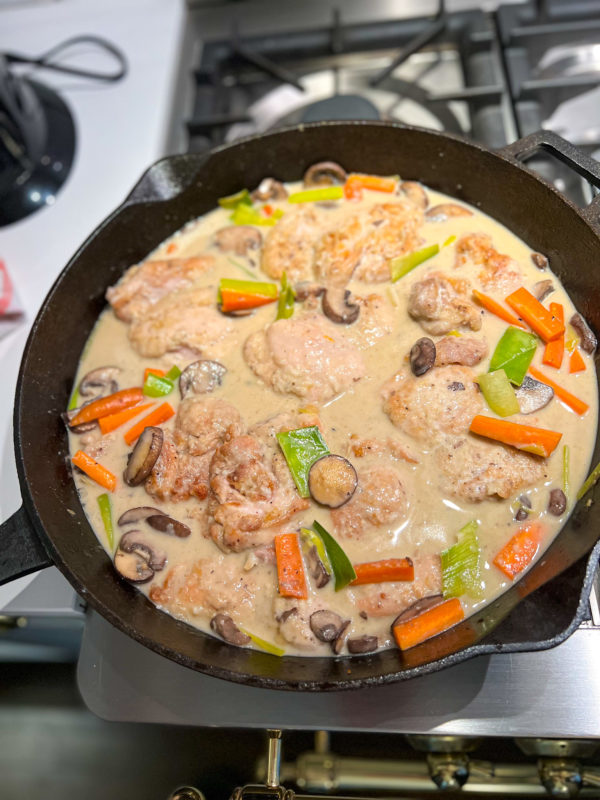 chicken in a mushroom cream sauce with carrots leeks and asparagus