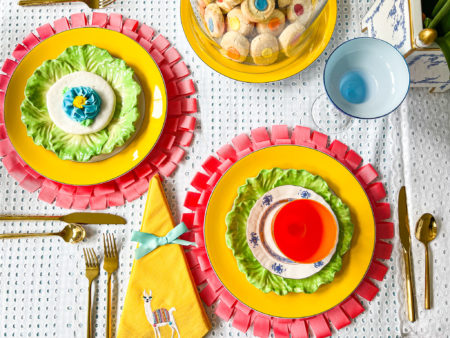 fancy fiesta table setting with bright colors and a stack of colorful shortbread thumbprint cookies