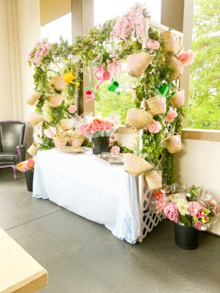 flower market party set up with white table cloth greenery flowers and straw baskets