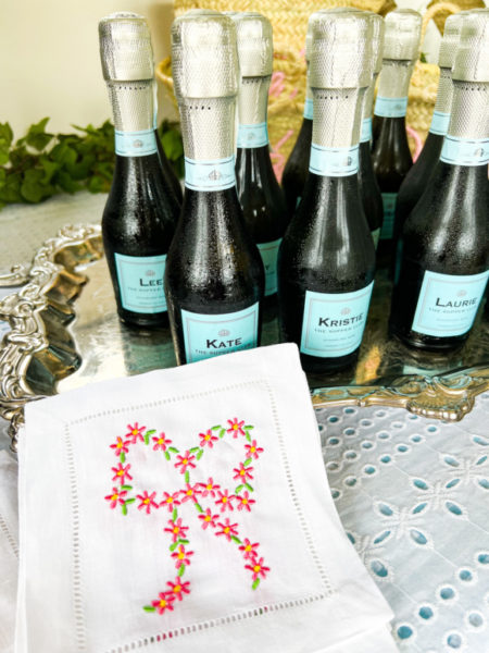 customized prosecco mini bottles with white square cocktail napkin embroidered with pink bow