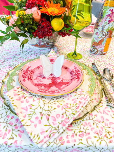 pink and green floral table linens and plates with baccarat butterfly