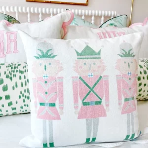 pink and green nutcracker pillow on child's bed