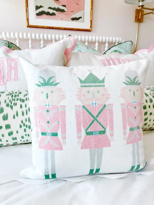 pink and green nutcracker pillow on child's bed