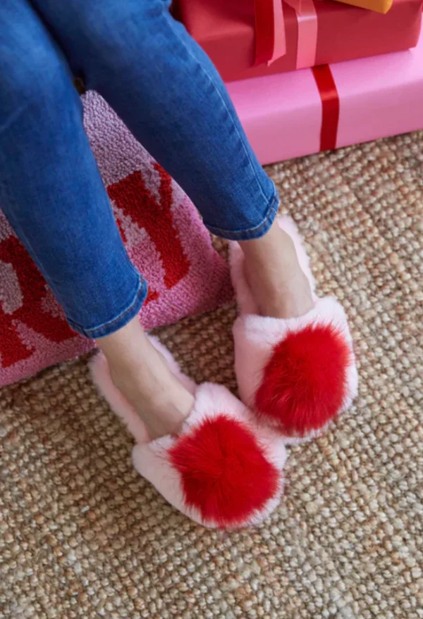 pink slippers with red pom pom
