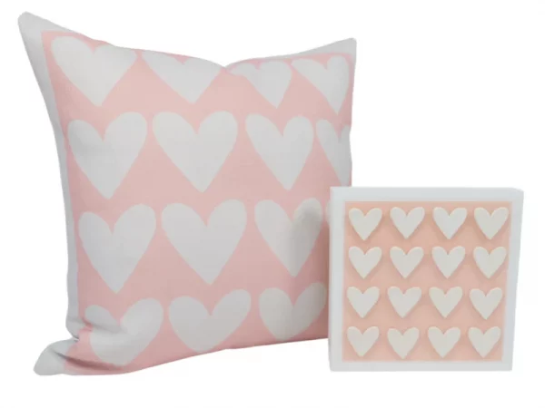 pink pillow with a grid of white hearts