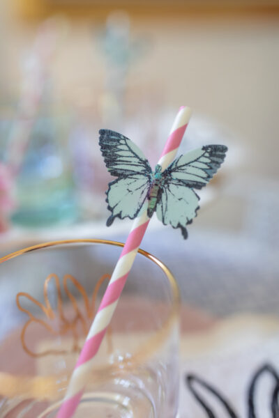 clear bunny glass with pink striped straw with edible blue wafer paper butterfly on straw