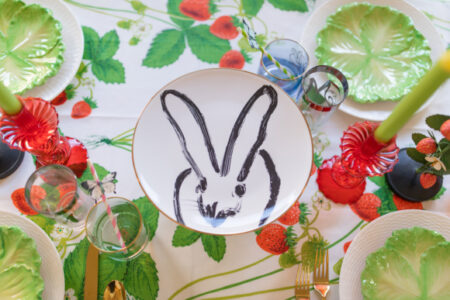 strawberry table setting with black and white bunny plate in middle of table