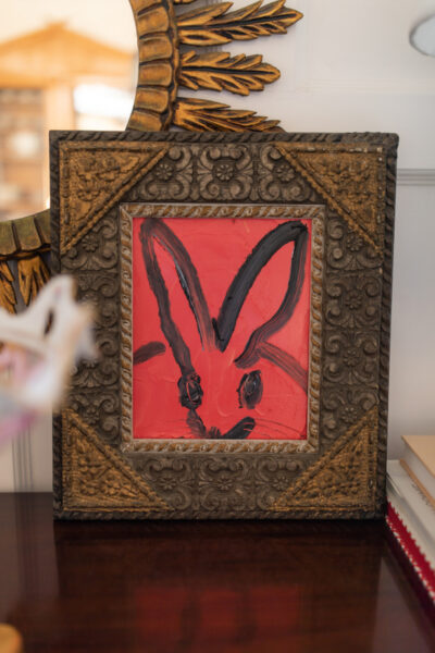 painting of bunny by hunt slonem with red background and black outline