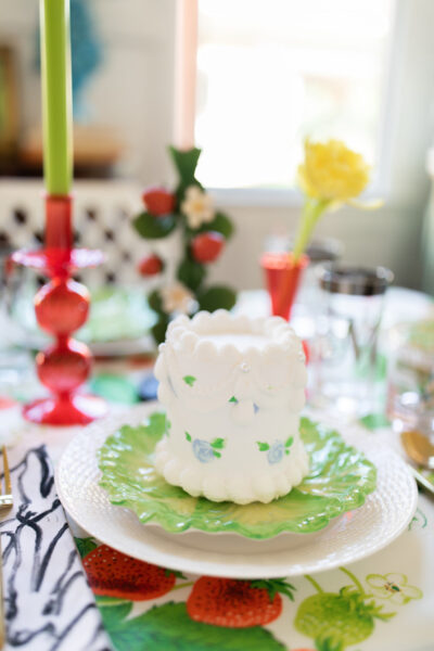 small white cake on table with strawberry theme
