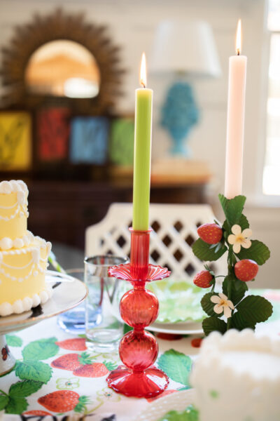 table set in primary colors with red candle sticks and green candles