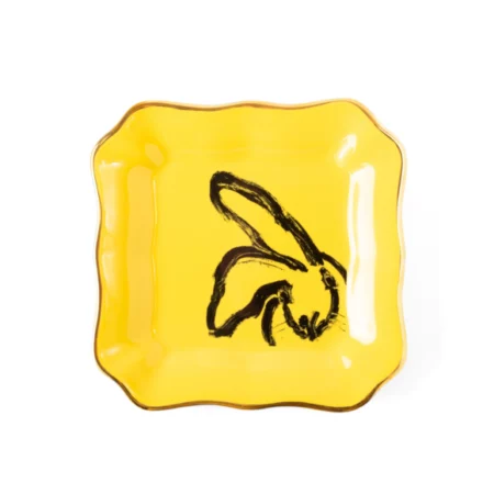 small square yellow plate with black bunny painted on it
