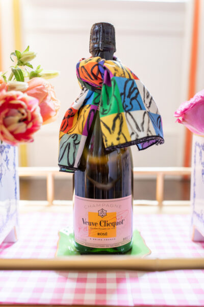 veuve rose champagne on bar cart with bunny napkin tied around the neck of bottle