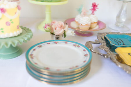 stack of vintage plates on dessert table for mothers day