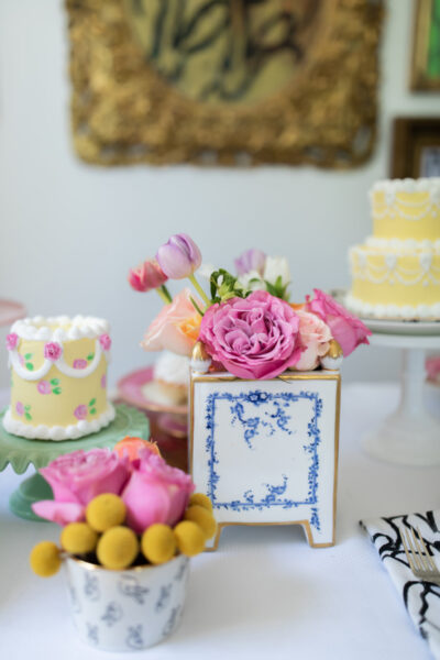 flowers and cakes on a table for mothers day